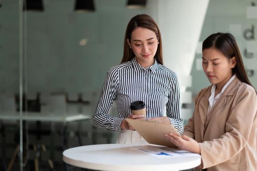 Group of asian businesswoman and Accountant checking data document on paperwork chart report for investigation of corruption account.