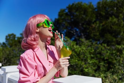fashionable woman with pink hair summer cocktail refreshing drink Summer day. High quality photo