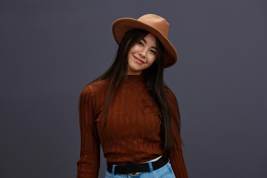 woman brown hat hand gestures brown sweater fashion emotions isolated background. High quality photo