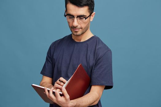 portrait man notepad with pen posing self confidence spectacled cropped view. High quality photo