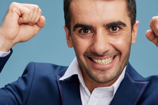 close-up of an emotional man in a suit with clenched fists near the face of boss employer isolated background. Copy space. High quality photo