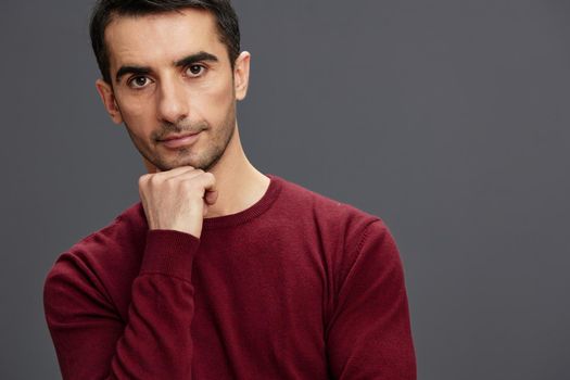 portrait man posing gesture hands red sweater cropped view. High quality photo