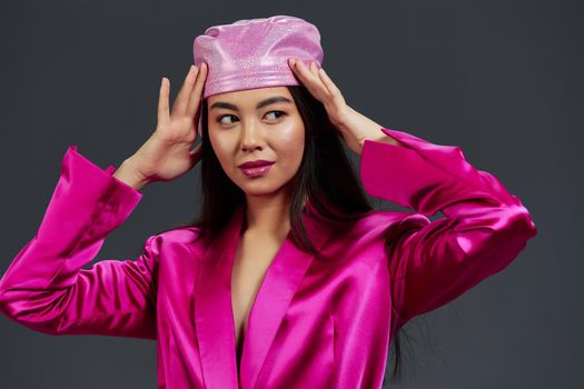 portrait woman in a pink mini dress pink headscarf luxury studio model. High quality photo