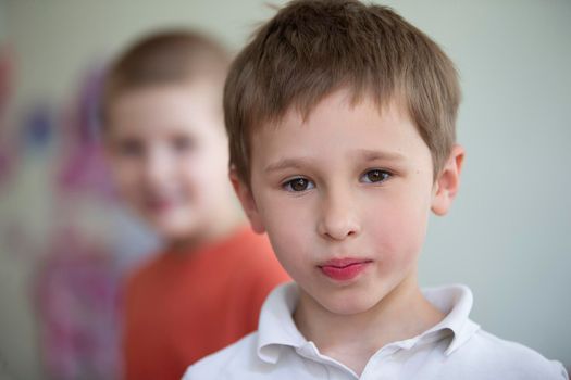The face of a five-year-old boy with brown eyes. The little boy looks into the camera.