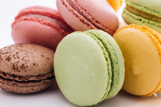 Multicolor macarons , French macaroon, greedy pastry. Close up of Multicolored Macarons Cookies. Food concept