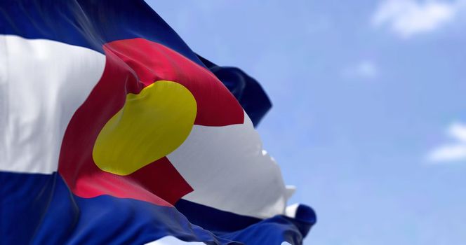 the flag of the US state of Colorado waving in the wind. Colorado was it admitted in 1876 as the 38th of the Union. Independence and unity