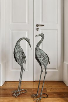 Luxury designer birds made of metal next to the white door