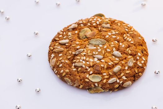 Wheat fall on dietary cookies. Eat oatmeal cookies. The concept of making chip cookies. Delicious tasty snack of brown cookies isolated on white background