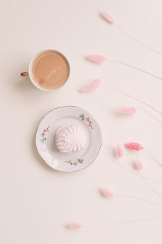 Good morning banner. Cup of coffee and homemade dessert zephyr. Top view. Food Photography with copy space. A cup of coffee and an airy marshmallow. Culinary background.