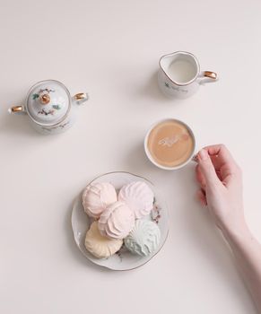 Good morning banner. Cup of coffee and homemade dessert zephyr. Top view. Food Photography with copy space. A cup of coffee and an airy marshmallow. Culinary background.