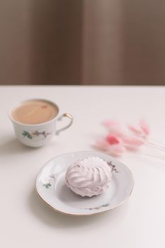 Good morning banner. Cup of coffee and homemade dessert zephyr. Top view. Food Photography with copy space. A cup of coffee and an airy marshmallow. Culinary background.