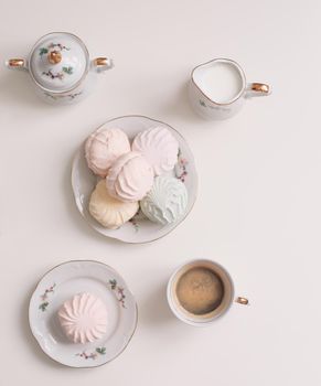 Good morning banner. Cup of coffee and homemade dessert zephyr. Top view. Food Photography with copy space. A cup of coffee and an airy marshmallow. Culinary background.