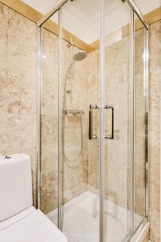 Luxury bathroom design with beige marble and tiled floor