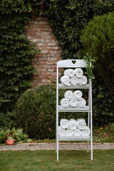 white plush blankets in wooden boxes for event invitees