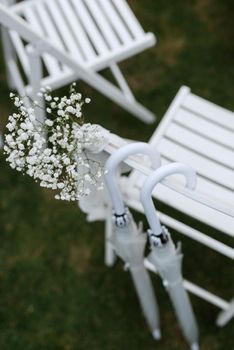 white wooden chairs for wedding ceremony on green grass