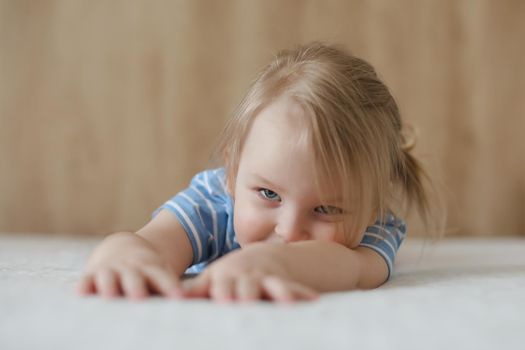 Portrait of child indoors. Happy funny toddler girl at home.