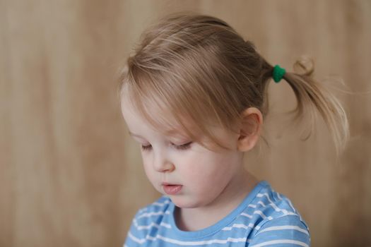 Portrait of child indoors. Happy funny toddler girl at home.