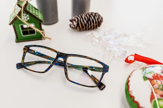 Glasses on a white table surrounded by accessories close up