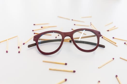 Glasses on a white table surrounded by matches close up