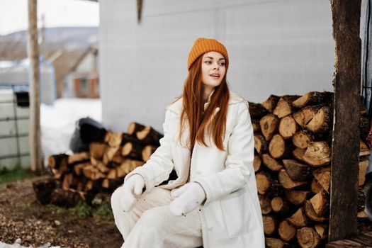 cheerful woman firewood for the stove price nature rest winter holidays. High quality photo