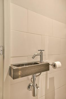 Marble sink and metal screen close-up in the toilet of a modern house