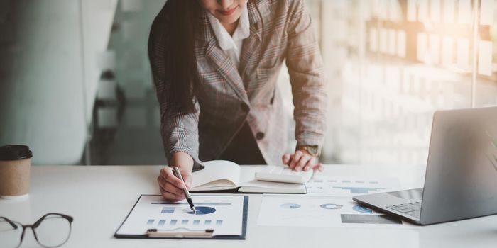 At Accounting office. Businessman calculating bills, tax and audit budget of company. statistics and credit analytic for mortgage payment concept