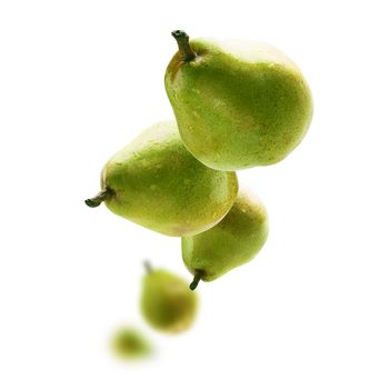 Green pears levitate on a white background.