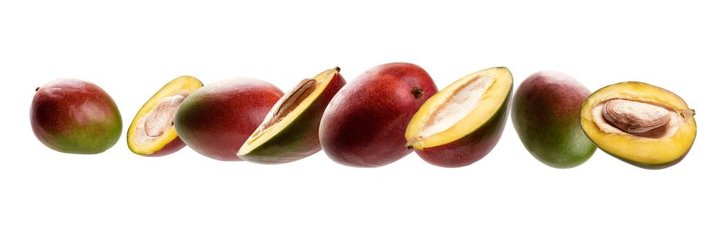 Mango whole and cut levitates on a white background.