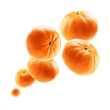 Orange tangerines levitate on a white background.