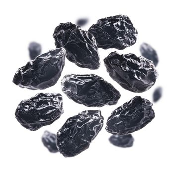 Dried prunes levitate on a white background.