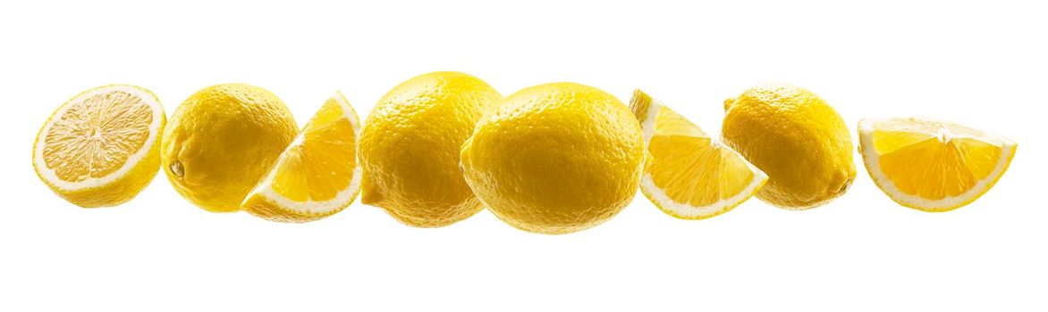 Yellow lemons levitate on a white background.