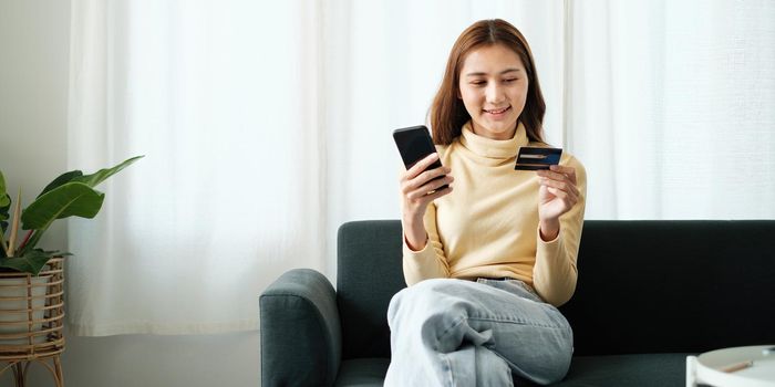 Woman using shopping application on smartphone and payment by credit card