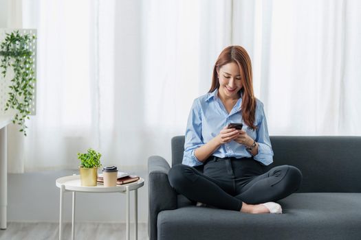 Woman using shopping application by cell phone and payment by credit card