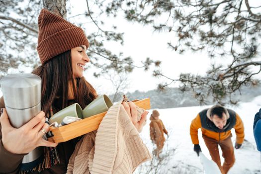 Young woman taking luggage out of car on winter trip, close up