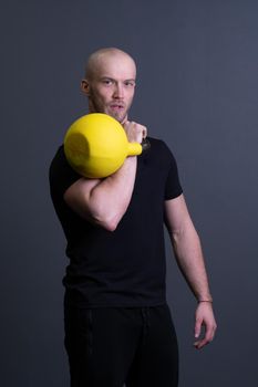 Guy with a yellow kettlebell gym anonymous yellow strength, from motivation teenager for strong and resitance sportswear, vietnamese filipino. Healthy bent health, club hiit