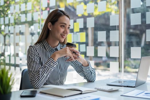 Successful business woman with coffee at office