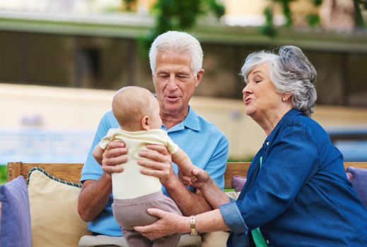 Cropped shot of a senior couple spending time with their grandson.