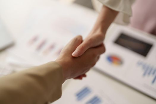 Close up of Business people shaking hands, finishing up meeting, business etiquette, congratulation, merger and acquisition concept.