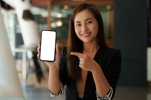 Woman showing smartphone with blank screen for advertise