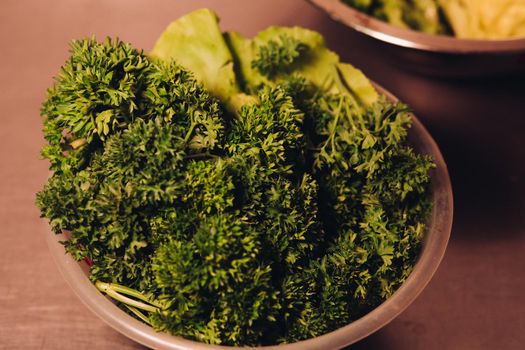 Close up of plate with tasty and fresh green leaf of salad and herbs. View of big delicious vitamins food for dinner. Vegetable and veg food for health.