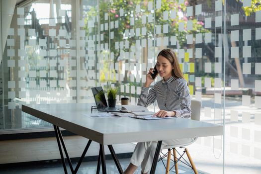 Asian Business woman working to analyze technical price graph and indicator. Account or saving money or insurance concept