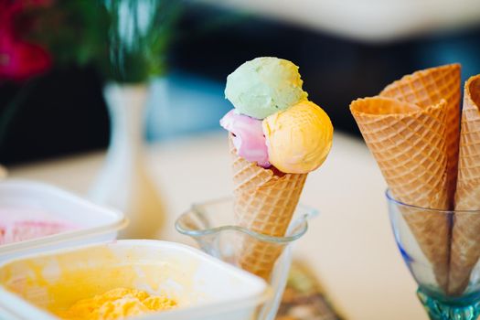 Close up of empty waffle cone in glass for ice cream. Tasty and sweet forms for ice cream in cafe on bar, perfect for summer heat. Concept of food and desert.