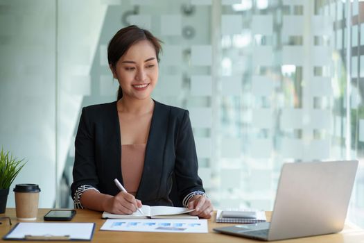 Secretary checking schedule at front of boss room