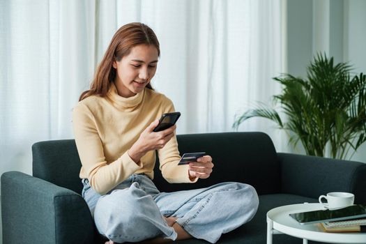 Woman using shopping application on smartphone and payment by credit card