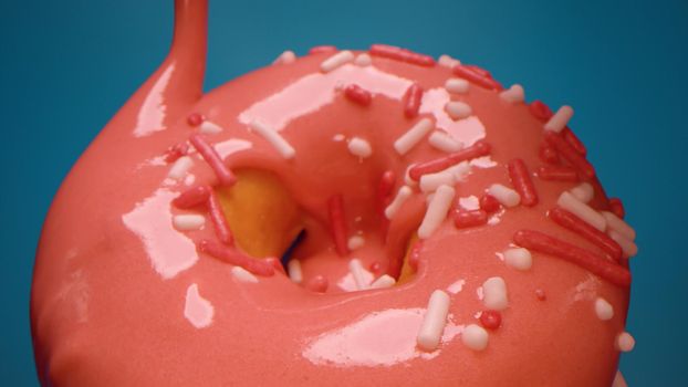 Extreme close up pink glaze pouring onto the donut on blue background. Tasty snack, dessert.