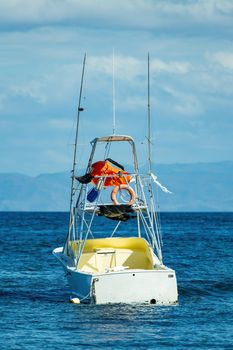 Motor boat anchored on Ocotal beach, view of Pacific ocean, El Coco Costa Rica. Pura Vida concept, travel to exotic tropical country.