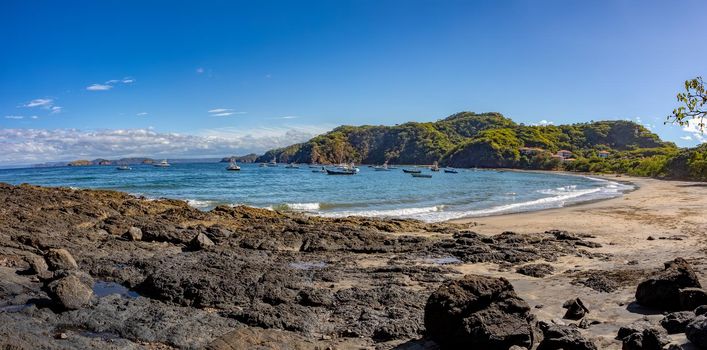 Playa Ocotal with Pacific ocean waves on rocky shore, El Coco Costa Rica. Famous snorkel beach. Picturesque paradise tropical landscape. Pura Vida concept, travel to exotic tropical country.