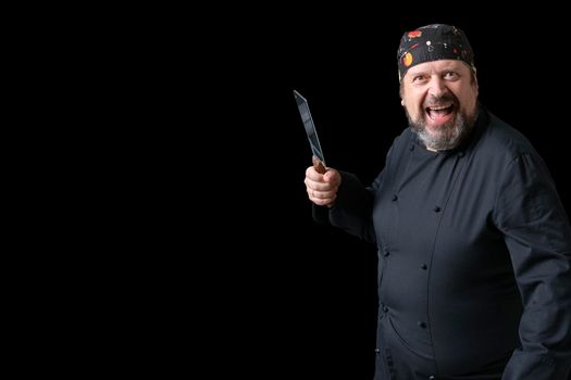 Portrait of cook with knife in hand with black background and copy space on the left side. Expressions of concept.