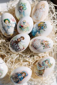 Lots of different drawings on goose eggs for Easter festival. Eggs on hay. Hand made print. Spring hollidays. Easter concept.