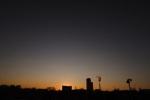 Dramatic landscape of a city skyline at sunset. Large city architecture 